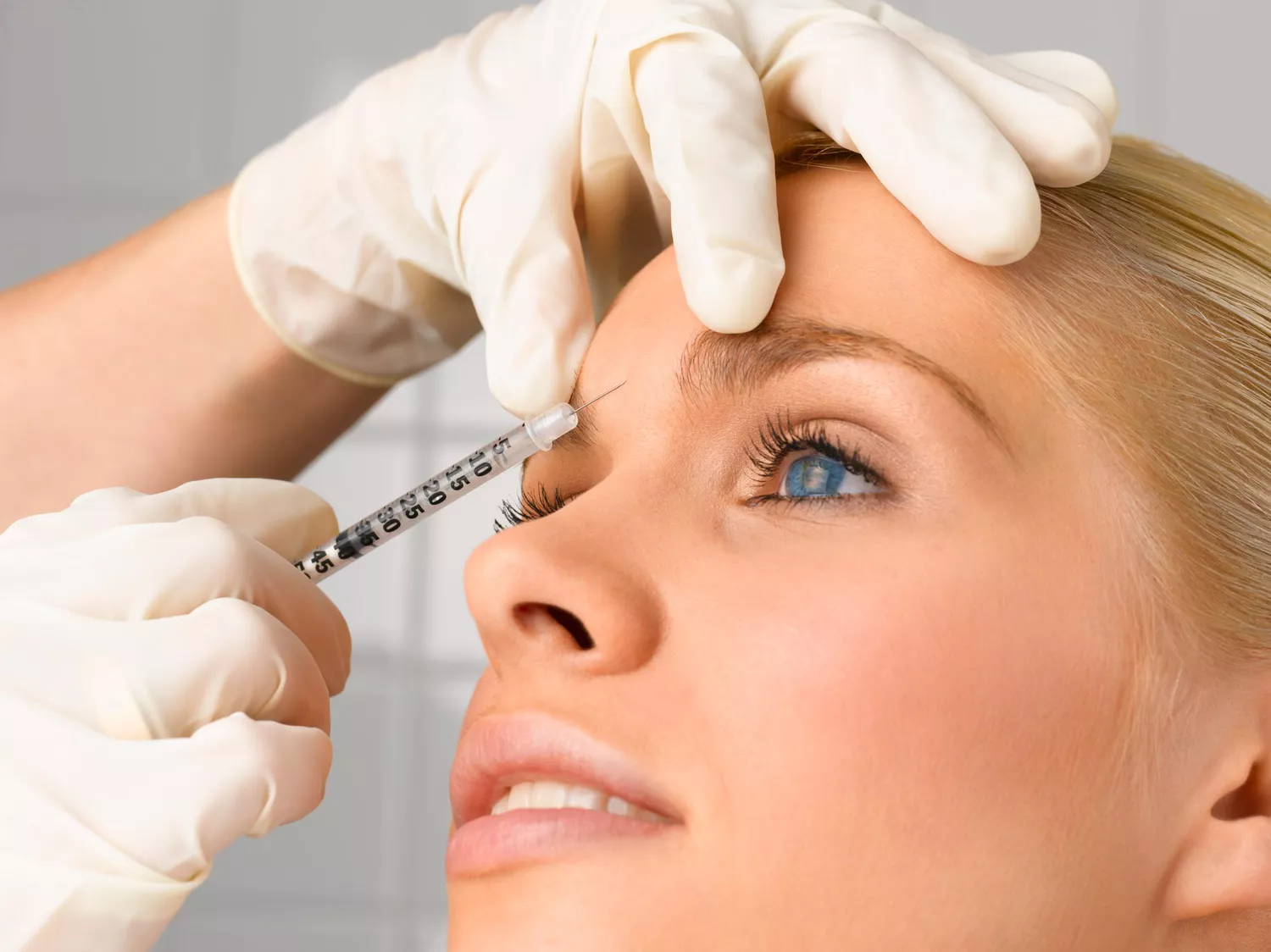 Nurse injecting Botox into a client's forehead