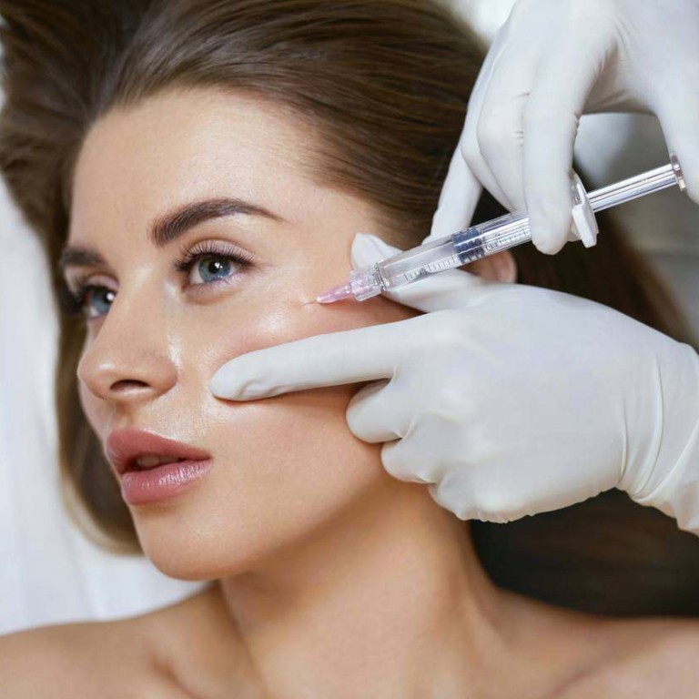 Nurse injecting a biostimulator into a client's cheek