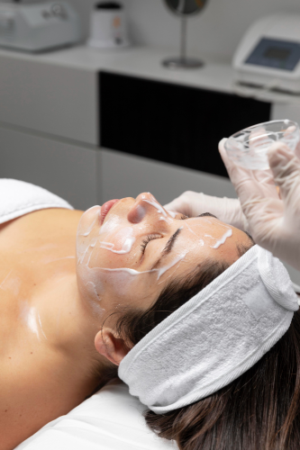 Woman receiving facial skincare treatment